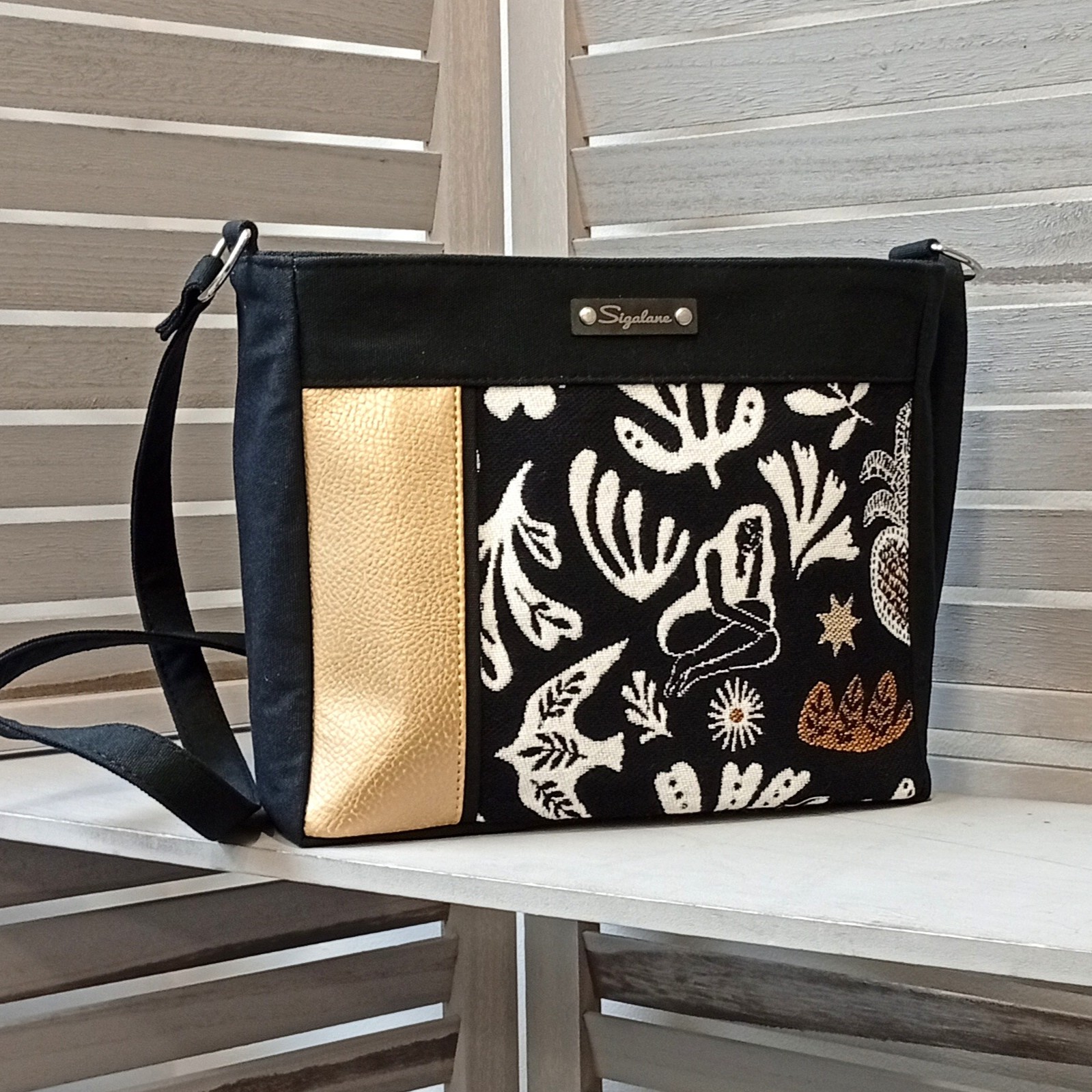 sigalane-sac-Dona-femme-assise-dore-et-uni-noir